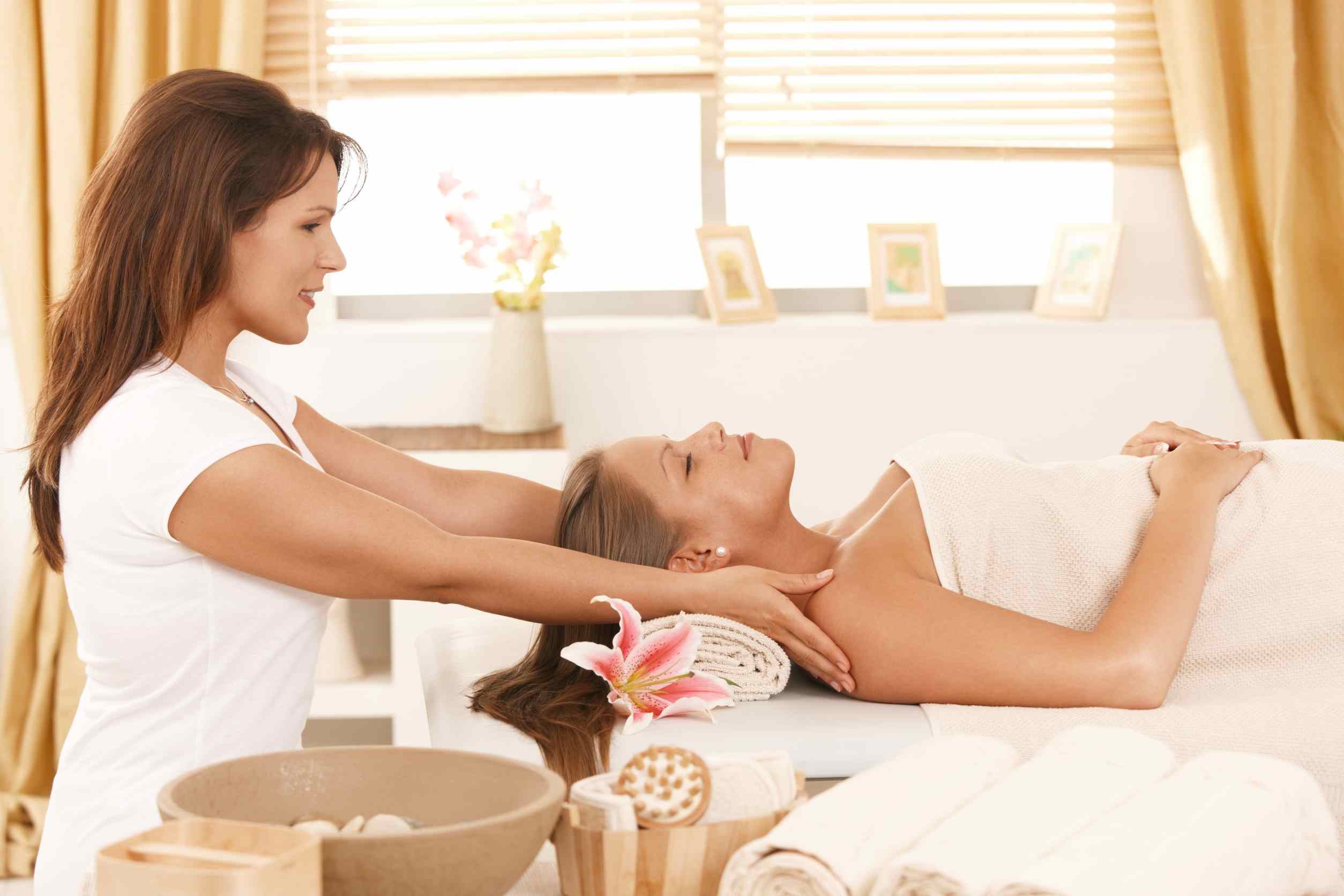 Therapist performing a hot stone massage